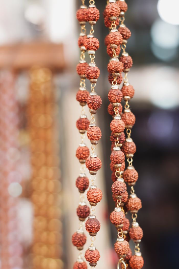 Crafting Captivating Headlines: Your awesome post title goes here Close-up of traditional Rudraksha beads hanging in a vibrant Varanasi street market.
