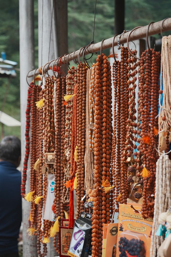 The Art of Drawing Readers In: Your attractive post title goes here A display of Rudraksha prayer beads hanging at an outdoor market, showcasing vibrant colors and textures.